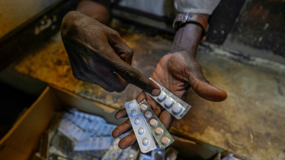 A person receives free medication in Sudan's capital. In Blue Nile to the south, displaced people have reported shortages of medicine and food