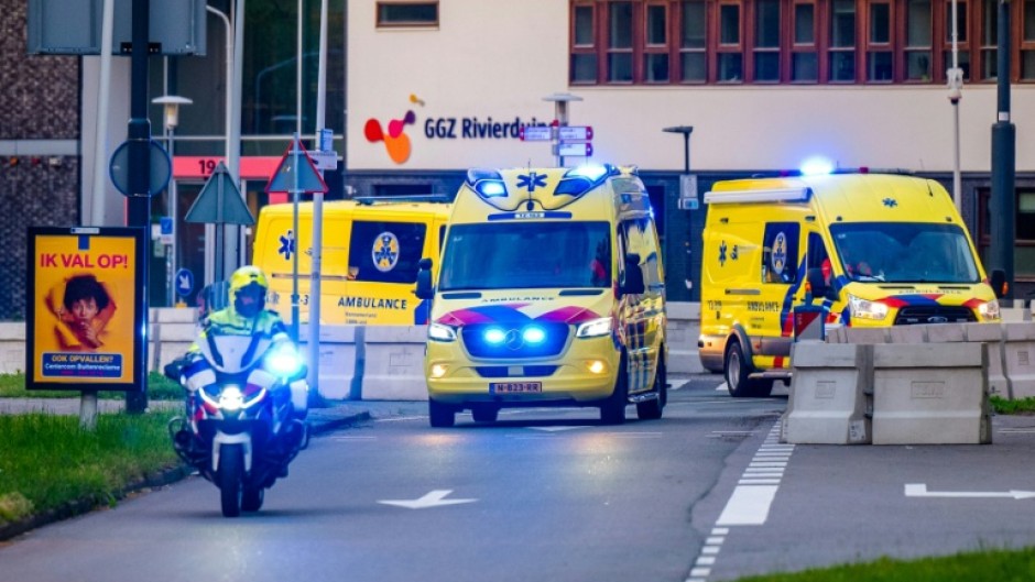 A convoy of ambulances believed to be carrying passengers evacuated from the cruise ship is escorted by Dutch police on motorcycles as it arrives at Leiden University Medical Center