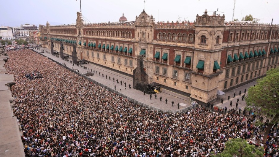 In this handout picture released by Mexico's presidencial press office, some 50,000 fans of South Korea's K-pop band BTS came to see the band at the Palacio Nacional in Mexico City