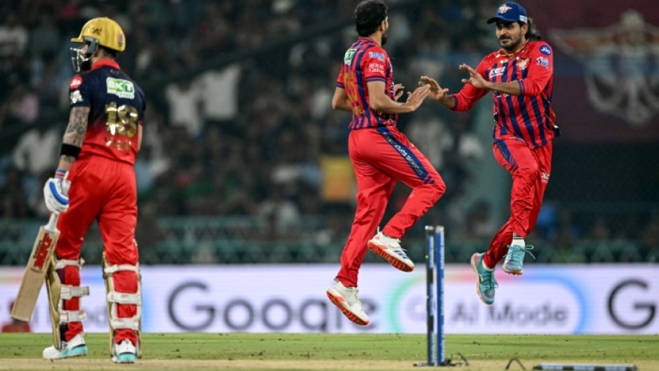 Prince Yadav (C) celebrates with Lucknow Super Giants team-mate Digvesh Rathi after dismissing Virat Kohli (L)