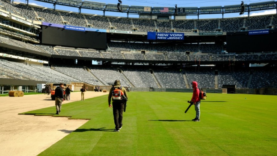 Pitch perfect: Workers install the pitch at New York New Jersey Stadium ahead of the 2026 FIFA World Cup
