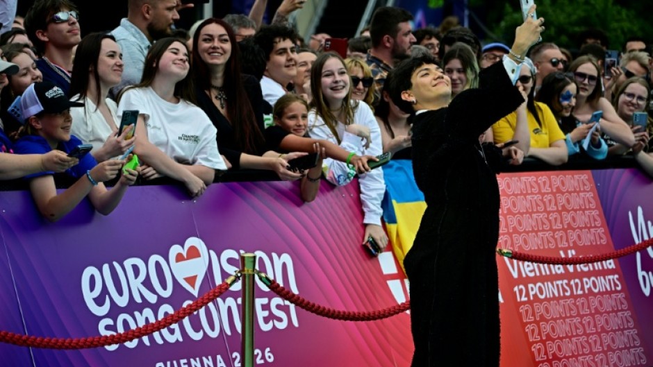 Austrian singer Johannes Pietsch, aka JJ poses on the turquoise carpet for the opening ceremony of the Eurovision Song Contest 2026 at the City Hall Square in Vienna, Austria