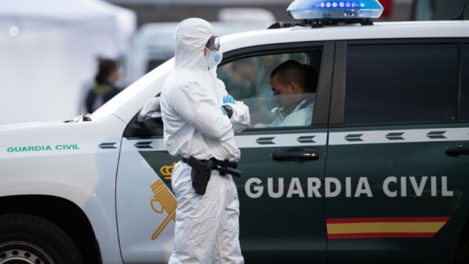 A Spanish civil guard wears a protective suit as the MV Hondius arrived at the industrial port of Granadilla de Abona on Tenerife on May 10, 2026