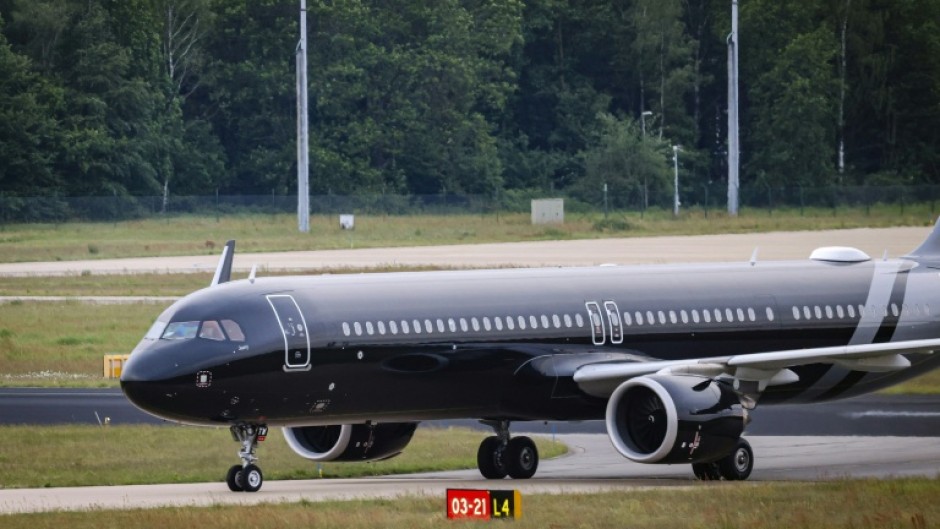 Passengers disembarked from the plane in groups