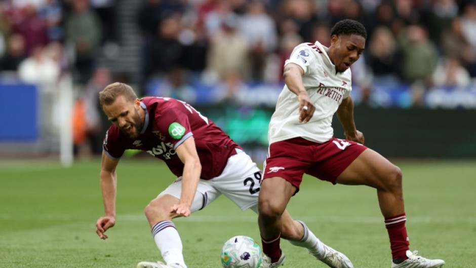 Arsenal's Myles Lewis-Skelly (R) tackles West Ham's Tomas Soucek (L) during the Gunners' 1-0 Premier League win at the London Stadium