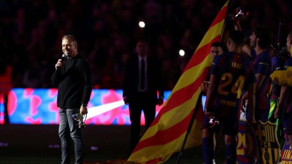 Hansi Flick speaks as Barcelona's players celebrate winning the 2025/26 La Liga title