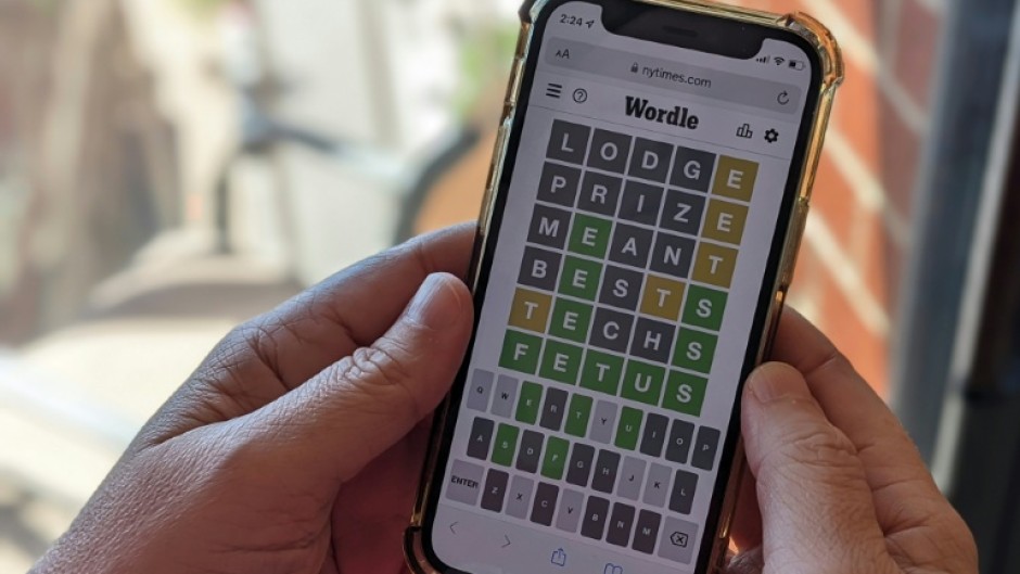 This photo illustration shows a person playing online word game Wordle on a mobile phone
