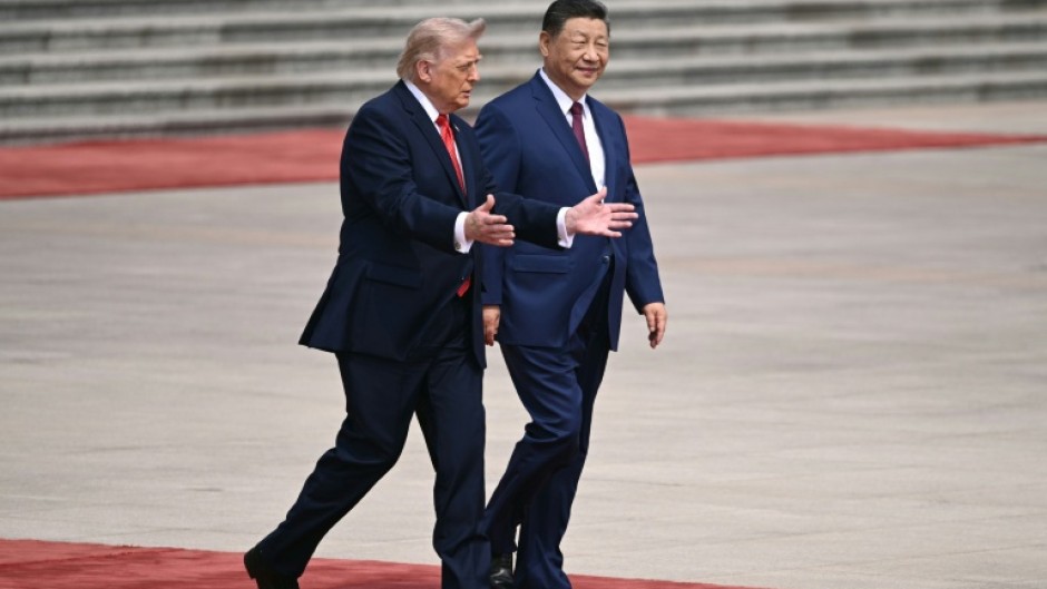 US President Donald Trump (L) takes part in a welcome ceremony with China's President Xi Jinping at the Great Hall of the People in Beijing