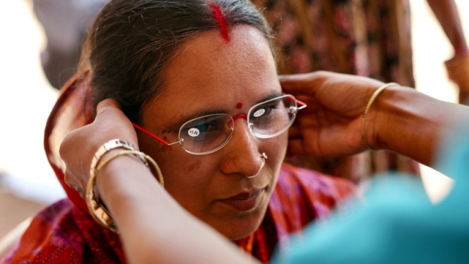 Weaver Savita Maharana tries on spectacles at GoodVision India – Care Netram charity's eye screening camp in Cuttack's Maniabandha village