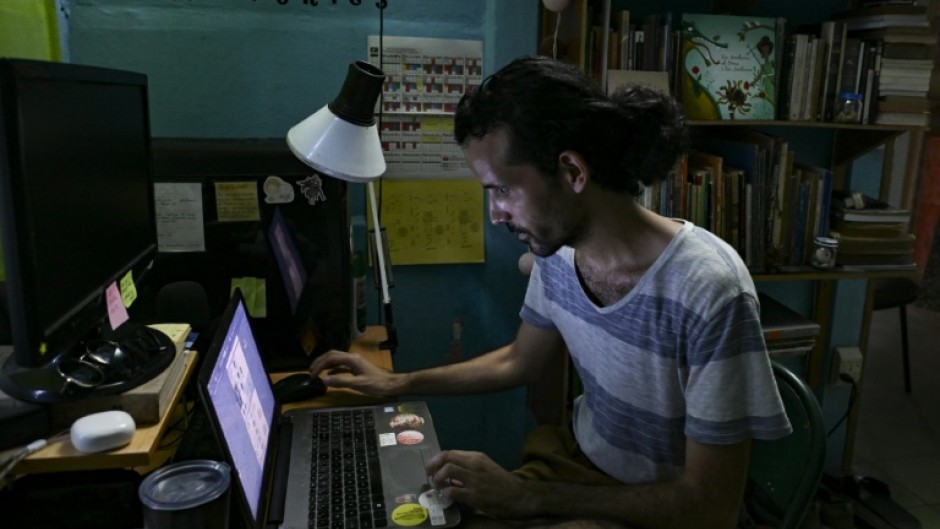 Alejandro Benitez a fourth-year Cuban architecture student, works during the night to try finish assignments that get delayed by incessant power outages