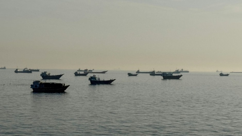 Vessels are seen anchored in the Strait of Hormuz, off the port city of Khasab on Oman's northern Musandam Peninsula on May 17, 2026