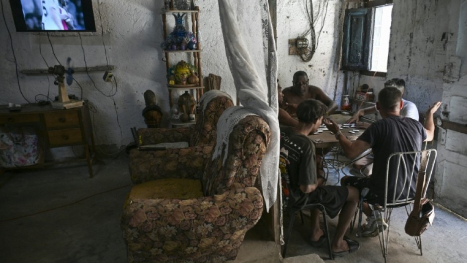 Havana residents play dominoes to pass the time amid frequent Cuban blackouts and the looming threat of US invasion