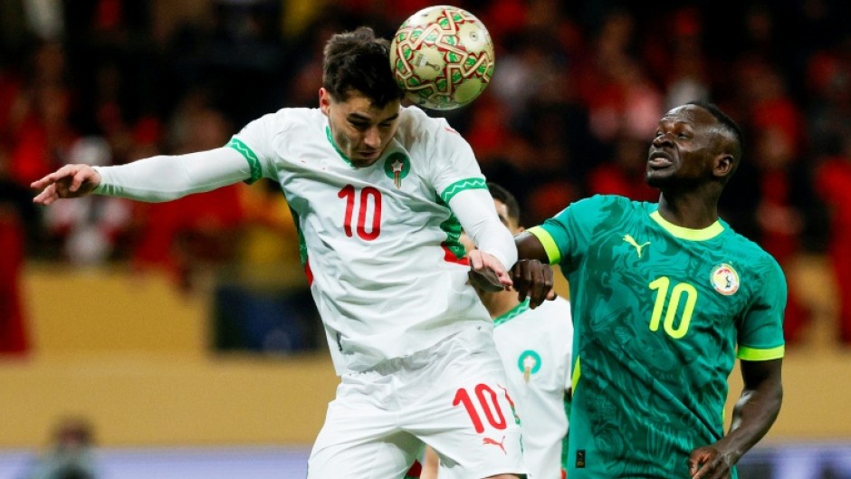 Morocco striker Brahim Diaz (L) heads the ball past Senegal captain Sadio Mane during the 2025 Africa Cup of Nations final in Rabat.