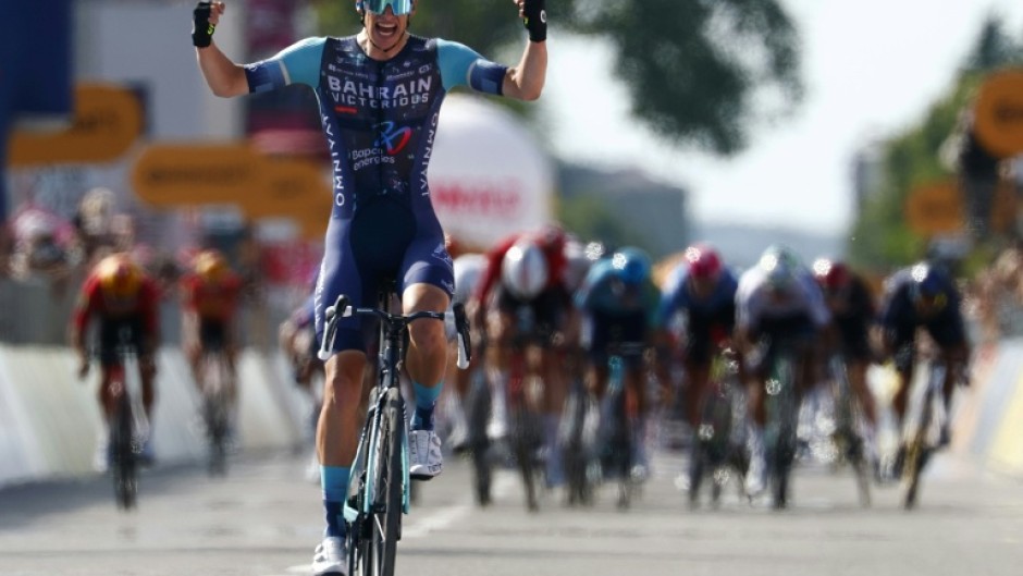 Alec Segaert celebrates as he crosses the line just ahead of the chasing pack