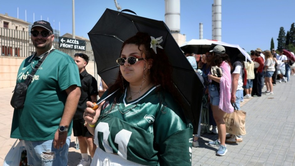 Fans queue outside the Estadi Olimpic Lluis Companys in Barcelona ahead of Bad Bunny's first concert in the Spanish city