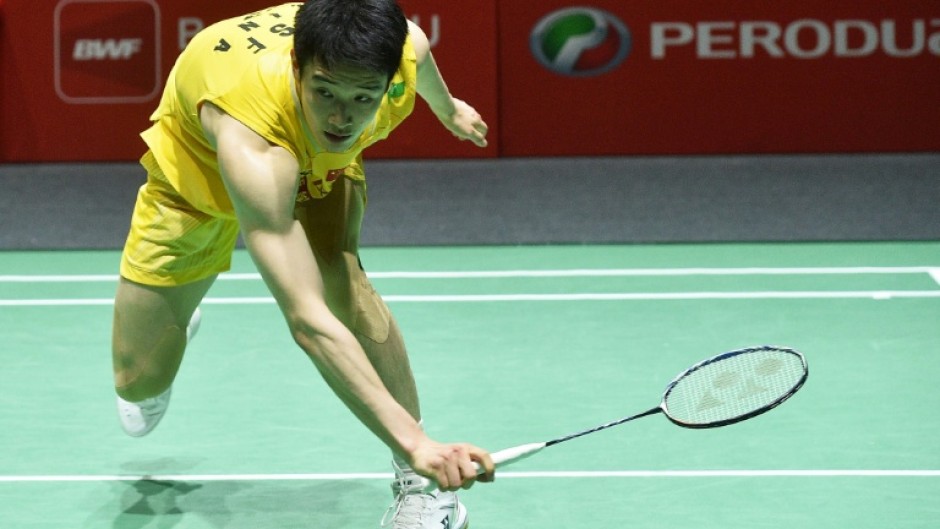 Li Shifeng of China in action against Panitchaphon Teeraratsakul of Thailand during their men's single final match