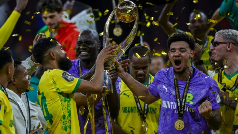 Keanu Cupido (L) and captain Ronwen Williams hold the CAF Champions League trophy after winning the final against FAR Rabat.