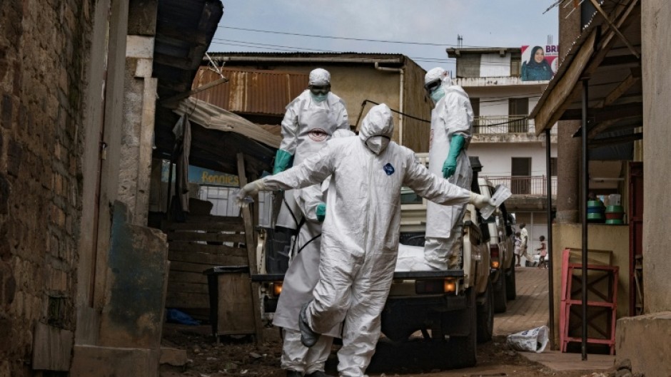A Ugandan Red Cross worker during the evacuation of the body of a suspected Ebola victim in Kampala on May 26