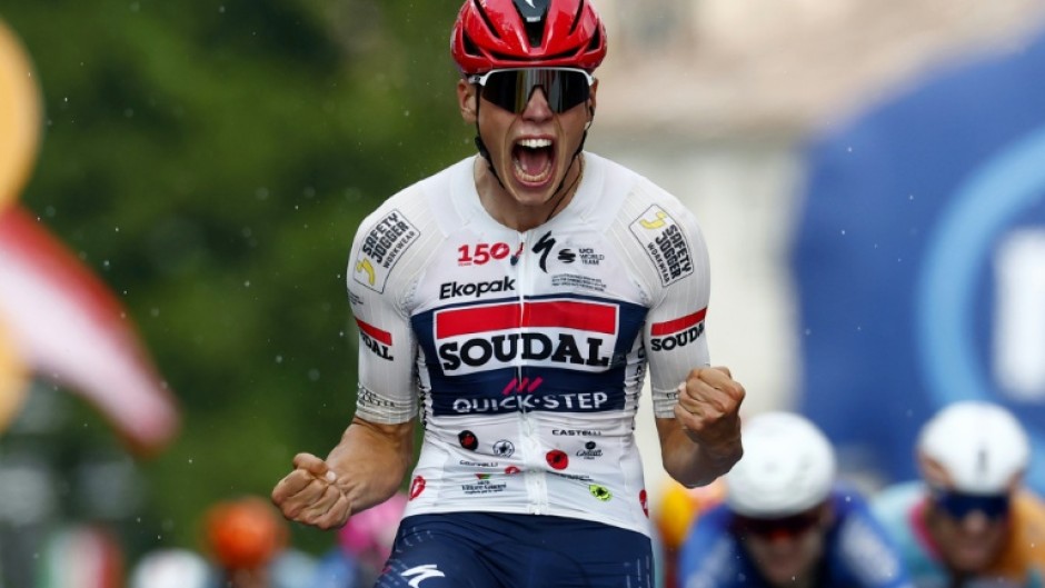 Soudal Quick-Step's French rider Paul Magnier celebrates as he wins the 18th stage of the Giro d'Italia at Pieve di Soligo