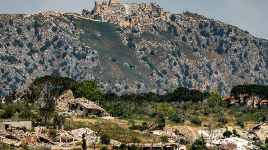 Destroyed buildings are pictured in the village of KfarKila in southern Lebanon as seen from across the border in the Upper Galilee region of northern Israel on May 29 with the Beaufort Castle pictured in Lebanon in the background