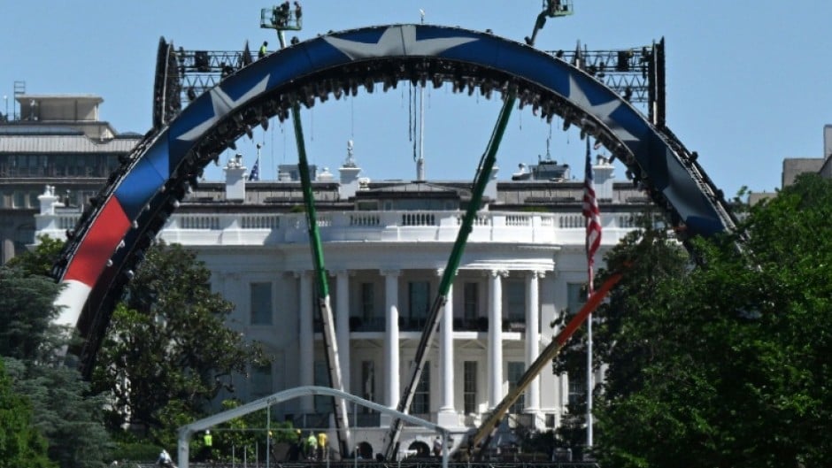 Crews work to build a mixed martial arts arena on the South Lawn of the White House for an upcoming fight that US President Donald Trump is staging as part of celebrations for the country's 250th anniversary