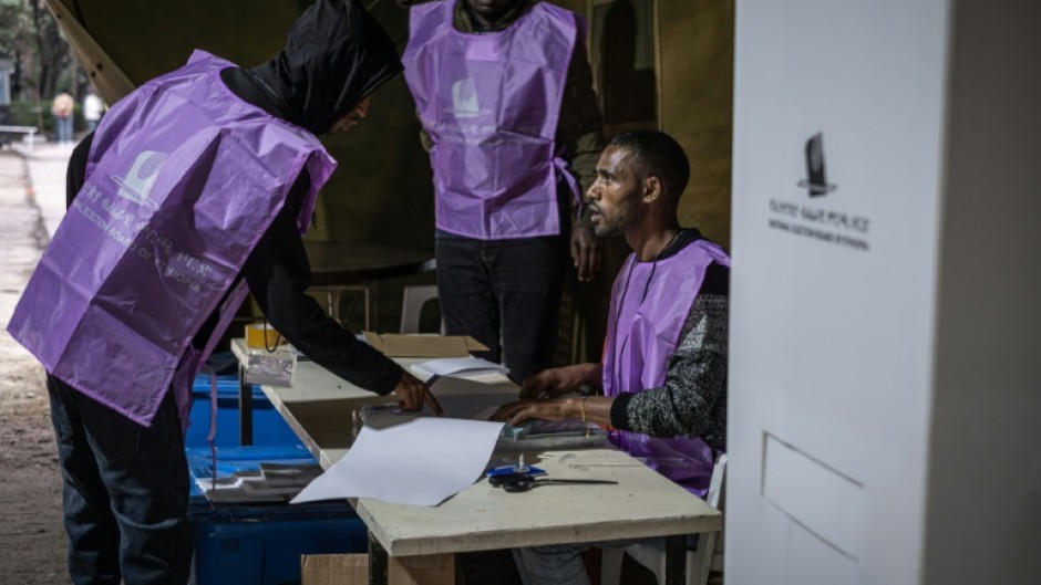 National Election Board of Ethiopia (NEBE) officials prepare voting materials ahead of the start of voting in Addis Ababa