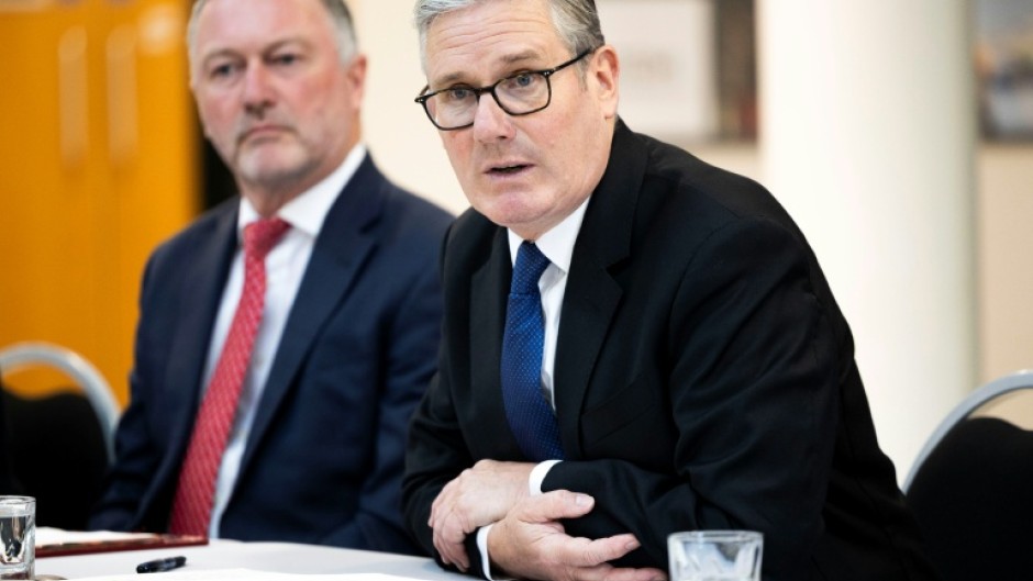 Britain's Prime Minister Keir Starmer (R) has clashed with Elon Musk previously