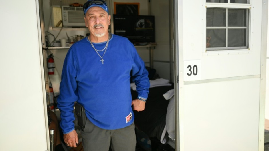 Michael Reyes poses inside a so-called tiny home in the Eagle Rock neighborhood of Los Angeles, California on June 1, 2026.