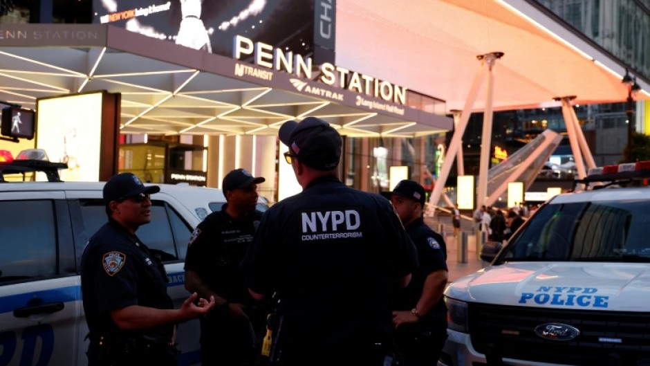 NYPD police officers are seen outside Penn Station in New York on June 7, 2026, after a stabbing attack inside the transit center