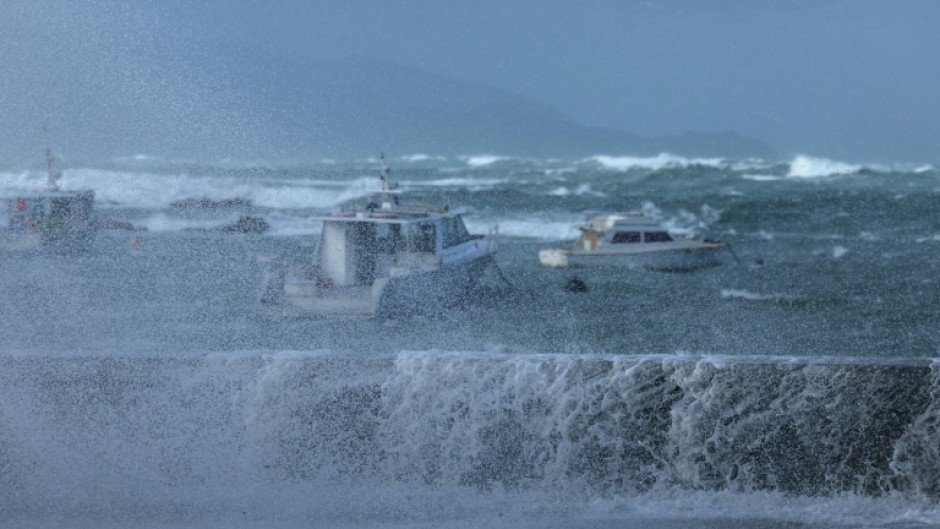 Stormy seas pound the coastline of Island Bay, a suburb of the New Zealand capital Wellington