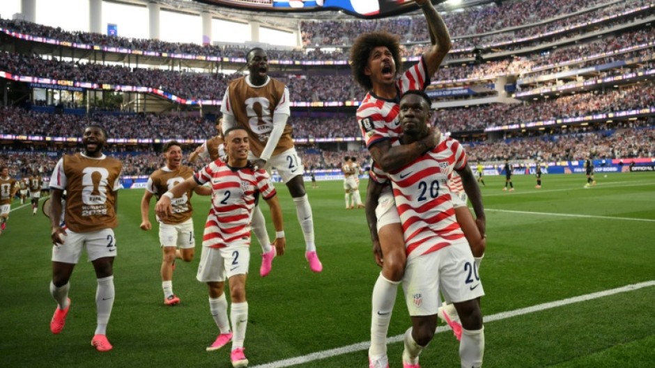 United States striker Folarin Balogun celebrates with team-mates after scoring in the World Cup co-hosts victory over Paraguay