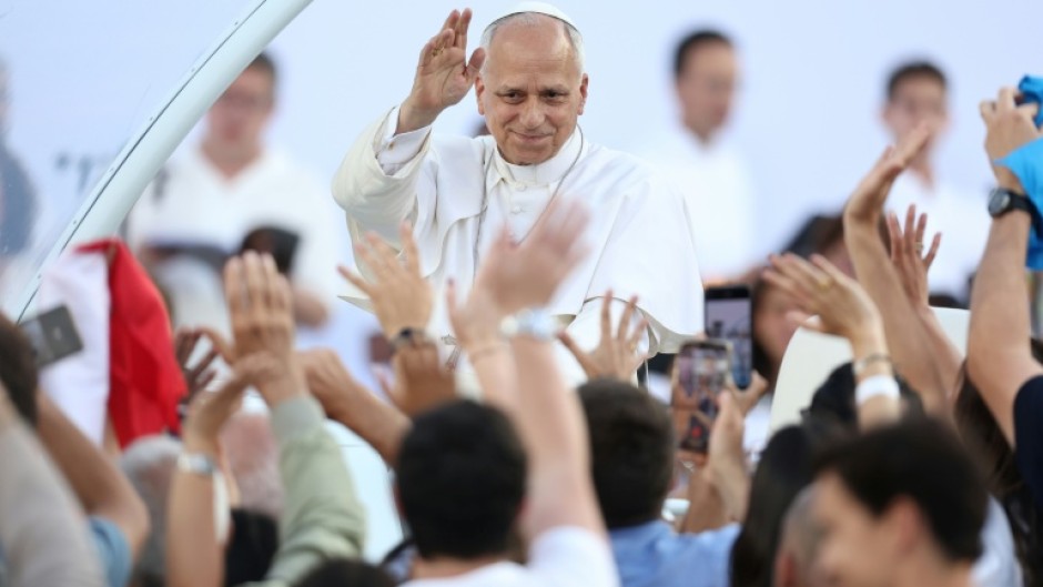 Pope Leo XIV greets the crowd as he arrives to attend a prayer vigil at the Olympic Stadium in Barcelona on June 9