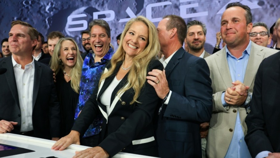 SpaceX president and chief operating officer Gwynne Shotwell (C) celebrates with SpaceX employees and executives