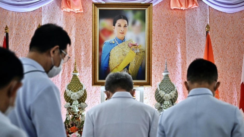 Well-wishers bow in front of an image of Thailand's Princess Bajrakitiyabha Mahidol, at Chulalongkorn Hospital in Bangkok