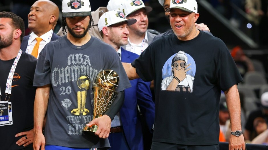 Jalen Brunson of the New York Knicks accepted the Bill Russell NBA Finals Most Valuable Player Award trophy with his father at his side