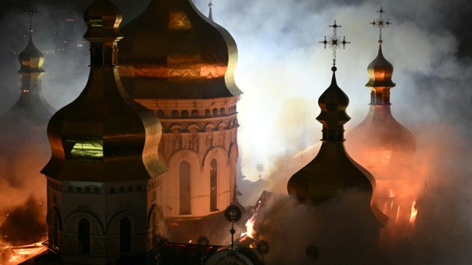 Smoke and fire rises from the Dormition Cathedral in the Orthodox in Kyiv