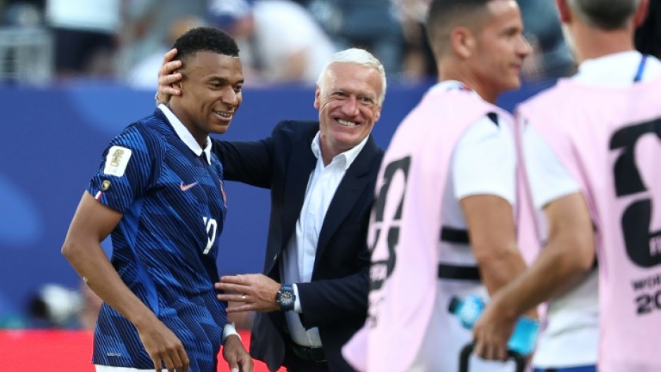 France coach Didier Deschamps congratulates Kylian Mbappe, who scored twice in his team's 3-1 win over Senegal on Tuesday at the World Cup