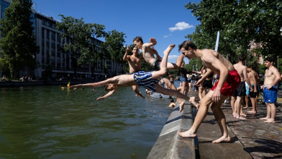 Young people dived into the Canal Saint-Martin in Paris to beat the heat