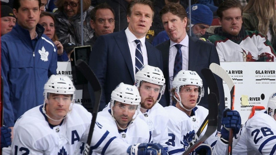 Jim Hiller, left center standing, was named the new head coach of the NHL Toronto Maple Leafs by the club, for which he was formerly an assistant coach