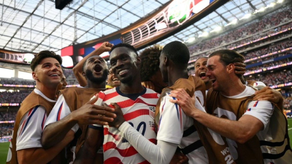 Folarin Balogun celebrates with his teammates after scoring the United States' third goal against Paraguay on June 12, 2026. The hosts went on to win 4-1 in the Group D match at Los Angeles Stadium