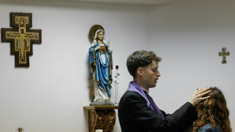 Self-proclaimed priest Francisco Marques lays his hands on a woman during an exorcism retreat in Portugal