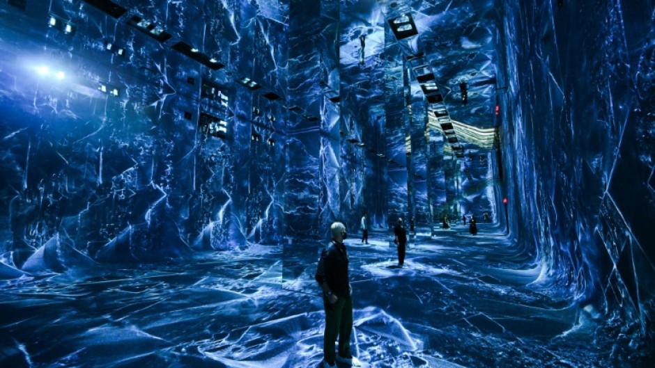 Attendees interact with immersive visualizations from the inaugural exhibition Machine Dreams: Rainforest are projected at DATALAND, the Museum of AI Arts