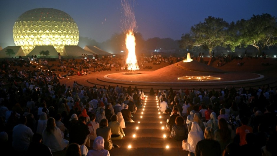 Huge draw: visitors and residents at a bonfire celebration near the 'Temple of the Mother' in India's Auroville spiritual community