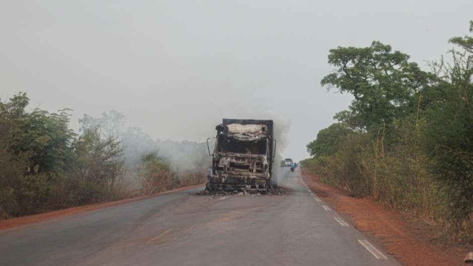 A burned truck is seen abandoned in the middle of the road leading to Sikasso, Mali in May 2026