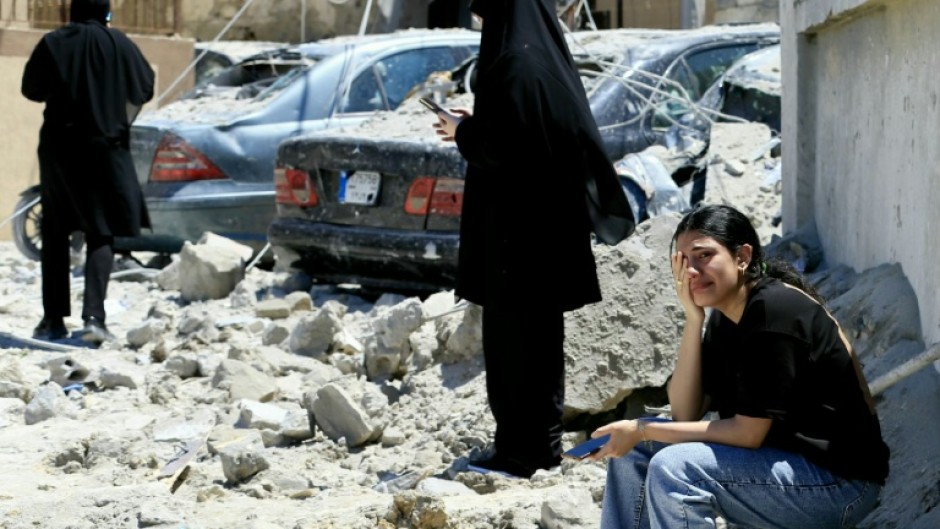 A woman weeps at the site of an Israeli airstrike that targeted the southern Lebanese village of Qennarit on June 20, 2026