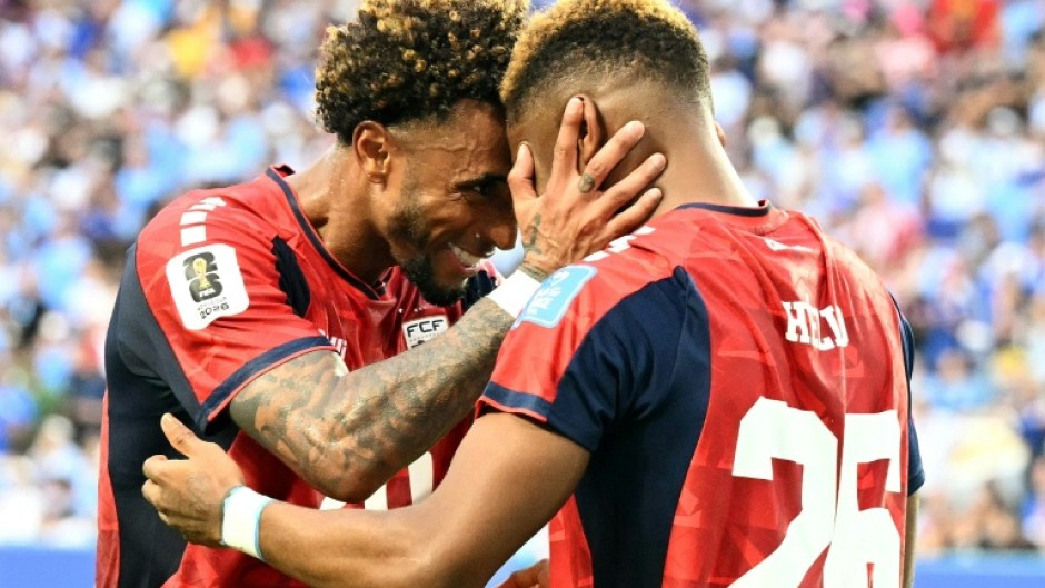 Cape Verde's forward Helio Varela (26) celebrates with teammate Ryan Mendes after scoring his team's equaliser in a 2-2 draw with Uruguay