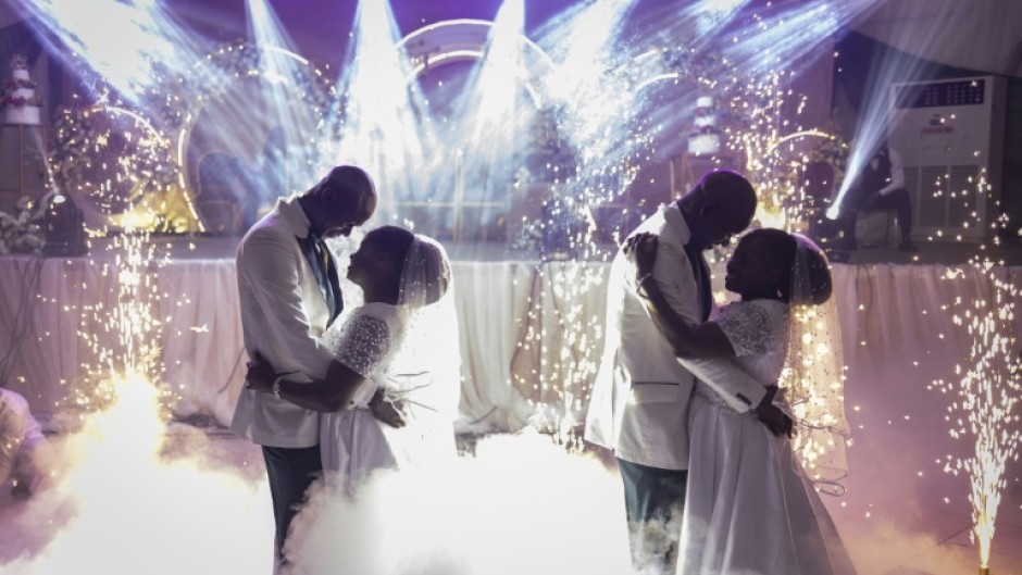 Twin brothers Taiwo and Kehinde Oguntoye dance with twin sisters Taiwo and Kehinde Adediran at their double wedding reception