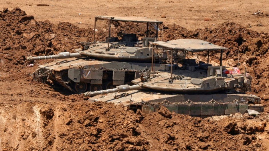 This picture taken from a position in the Upper Galilee in northern Israel shows Israeli tanks positioned along the border with southern Lebanon on June 22, 2026