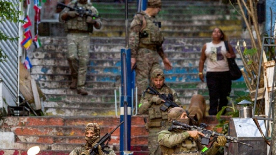 Brazilian special police forces patrol a street during an operation in the Santa Marta favela