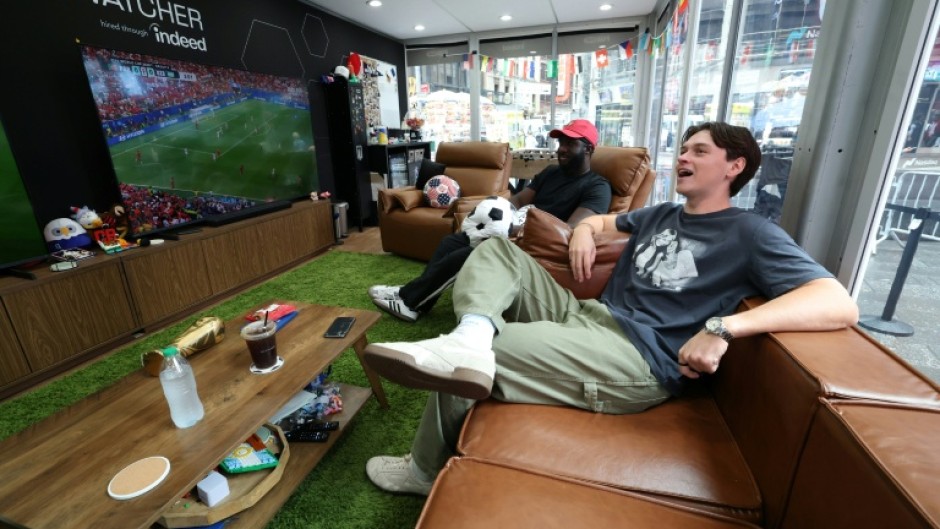 Austin Franklin (right) and Kevin Akoto have a dream job: Getting paid to watch all 104 games of the World Cup in a cube-like studio in the heart of New York's Times Square